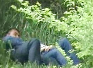 Horny couple feels an urge to caress each other in a park