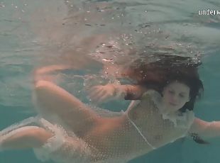 Sexy babe gets out of her white dress while being under the water