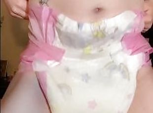 Baby girl shows off her soaked diaper