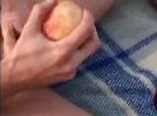 boy jerks off his dick with a peach