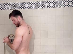 Muscular hairy hunk getting soapy in the shower