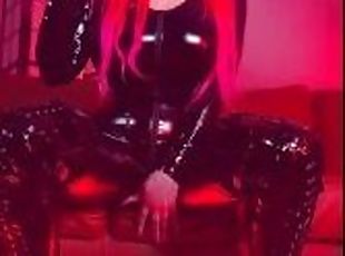 Pink haired Luvie Doll smoking EVE 120s cigarette in a PVC catsuit looking like the devil with nails