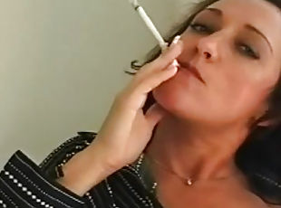 Brunette with sexy face smokes a cigarette with pleasure