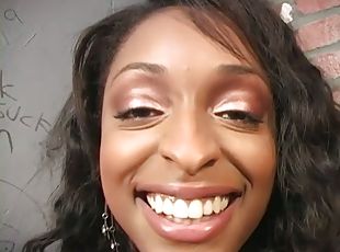 Busty ebony girl blows a cock in a gloryhole video