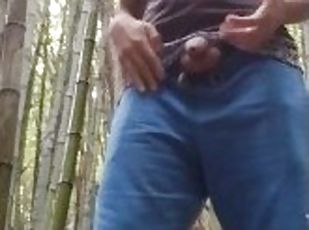 man alone in the woods peeing and relaxing