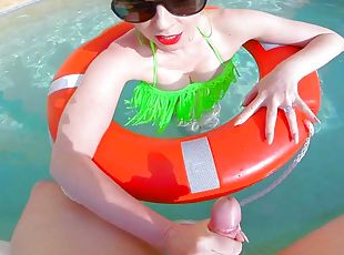 Beautiful busty redhead mature is out in the pool in her green bikini
