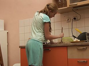 Petite Jessica Neight plays with her shaved pussy in the kitchen