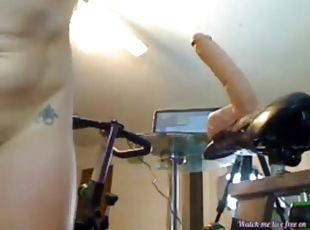 Blonde riding a huge dildo on a bicycle on webcam