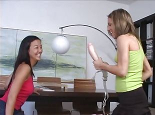 Asian lesbian gets fucked by a white blonde with a big strapon dildo