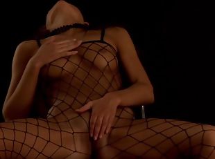 Shelby wears a fishnet suit during a fingering game