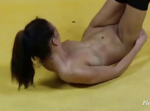 Flexible teen does a backbend and a split being naked
