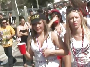 Nasty girls demonstrate their tits at a carnival in reality scene