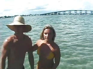 Bikini girl gives him a blowjob in the ocean