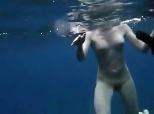 Beautiful girls swim naked in the deep ocean