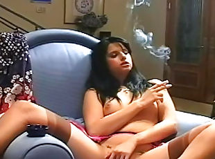 Perverted brunette is smoking a cigarette in a sexy way