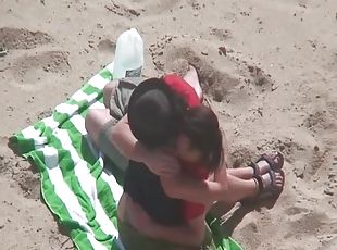 Kissing and tit sucking on the beach with a couple