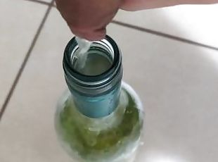 Filling up a 750mL bottle of wine with piss