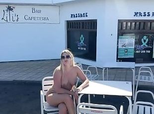 girl sitting naked in a cafe in public